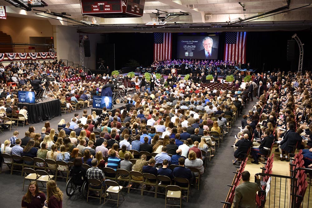 The campus gymnasium is full to hear Forbes. He spoke on federal tax and health care reforms, and promoted free-market economics.